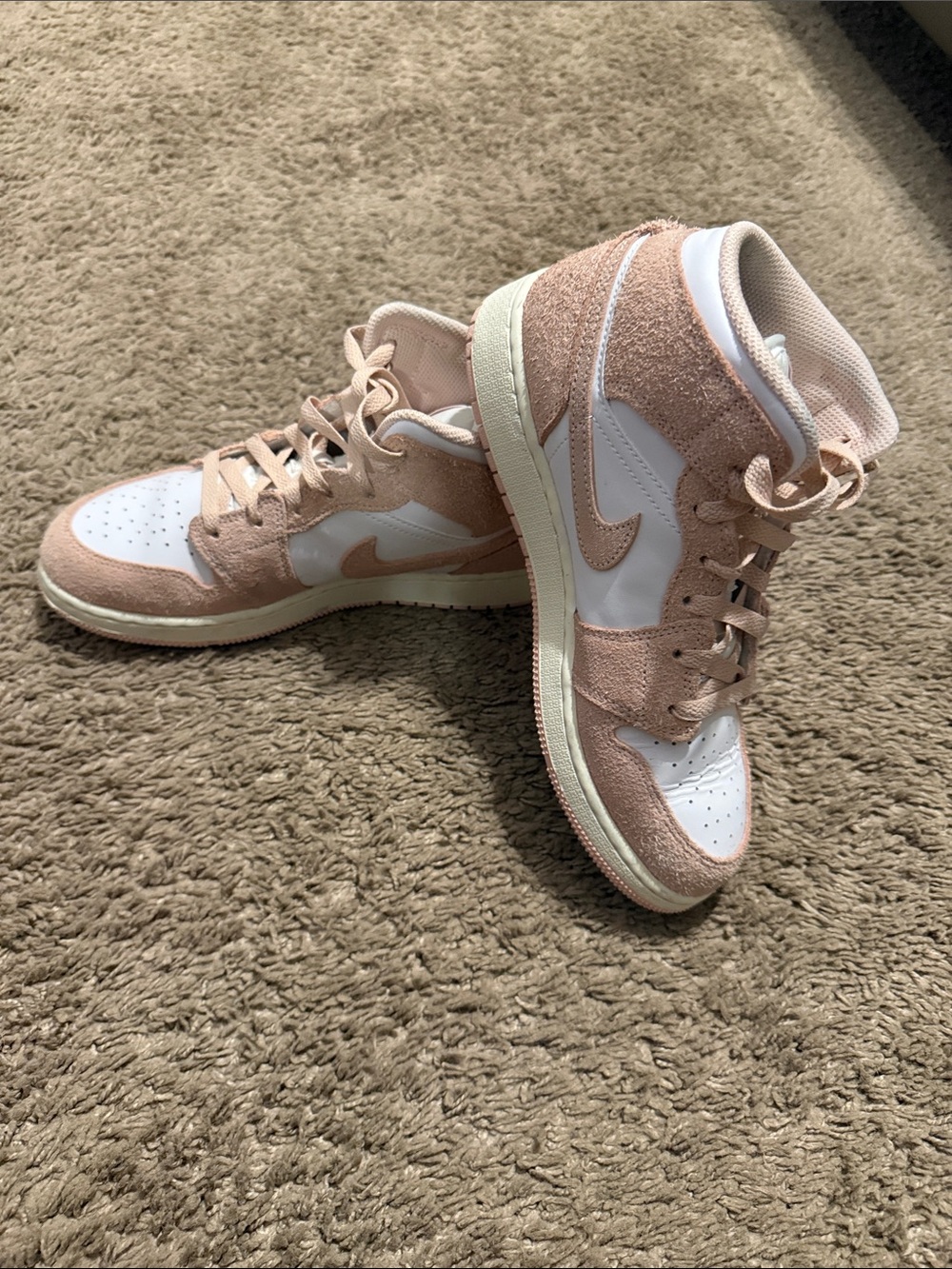 Jordan Nike High-Top Sneakers in Blush Pink and White.